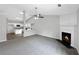 Open concept living area with a fireplace and views into the modern kitchen at 2628 Downingwood Ln, Grayson, GA 30017