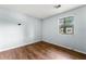 This cozy bedroom features wood-look floors and a window providing natural light at 5445 Mallard Trl, Lithonia, GA 30058