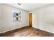 A bedroom with wood floors, natural light from a window, and a closet at 5445 Mallard Trl, Lithonia, GA 30058