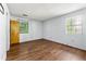 Spacious bedroom featuring wood-look floors and natural light from the windows at 5445 Mallard Trl, Lithonia, GA 30058