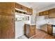 A kitchen features wood cabinets and a pass through window to the living room at 5445 Mallard Trl, Lithonia, GA 30058