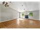 A spacious living room features a stone fireplace, wood floors, and natural light at 5445 Mallard Trl, Lithonia, GA 30058