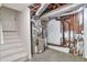 Basement with utility connections and painted staircase, ready for renovation and customization at 5911 Christopher Ln, Lithonia, GA 30058