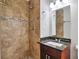 Bathroom showcasing a tiled shower and granite vanity at 5911 Christopher Ln, Lithonia, GA 30058