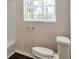 Bright bathroom featuring a commode and towel rack at 5911 Christopher Ln, Lithonia, GA 30058