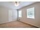 Bedroom with neutral walls, carpeted floors, two windows with blinds, and a ceiling fan for added comfort at 5911 Christopher Ln, Lithonia, GA 30058
