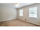 Carpeted bedroom with natural light from two windows at 5911 Christopher Ln, Lithonia, GA 30058