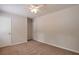 This carpeted bedroom features a ceiling fan and closet at 5911 Christopher Ln, Lithonia, GA 30058
