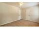 Neutral bedroom boasts carpeted floors, two doors, and a ceiling fan, providing a blank canvas at 5911 Christopher Ln, Lithonia, GA 30058