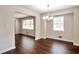 Inviting dining room featuring hardwood floors, neutral paint, and a modern chandelier at 5911 Christopher Ln, Lithonia, GA 30058