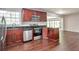 Modern kitchen featuring granite countertops, stainless steel appliances, and cherry wood cabinets at 5911 Christopher Ln, Lithonia, GA 30058