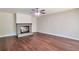 Open-concept living area featuring hardwood floors, a brick fireplace, and neutral paint at 5911 Christopher Ln, Lithonia, GA 30058