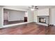 Bright living room featuring hardwood floors, a brick fireplace, and access to other rooms at 5911 Christopher Ln, Lithonia, GA 30058