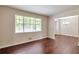 Bright living room features hardwood floors, neutral paint, and a large window with natural light at 5911 Christopher Ln, Lithonia, GA 30058