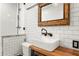 This bathroom features white subway tiles, a barn door mirror, and modern fixtures at 960 Taft Ne Ave # 9, Atlanta, GA 30309