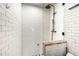 This bathroom features white subway tiles and an open shower with a stone base at 960 Taft Ne Ave # 9, Atlanta, GA 30309