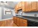 Kitchen area with wooden cabinets, view to living area and stainless sink at 960 Taft Ne Ave # 9, Atlanta, GA 30309