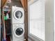 Bright laundry area features stackable washer and dryer near window at 960 Taft Ne Ave # 9, Atlanta, GA 30309
