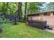 Private backyard oasis with a covered hot tub, lawn, and lush landscaping at 1583 Nantahalla Ne Ct, Atlanta, GA 30329
