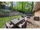 Outdoor patio with comfortable seating, dining area, lush greenery, and a stone retaining wall at 1583 Nantahalla Ne Ct, Atlanta, GA 30329