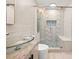 Bathroom featuring a glass bowl sink, modern fixtures, and a walk-in shower with designer tiling at 1583 Nantahalla Ne Ct, Atlanta, GA 30329