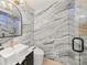 Modern bathroom with marble walls, a sleek vanity, and a walk-in shower at 1583 Nantahalla Ne Ct, Atlanta, GA 30329