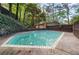 Backyard featuring a spacious in-ground pool, lush greenery, and privacy fencing at 1583 Nantahalla Ne Ct, Atlanta, GA 30329