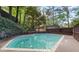 Backyard pool with brick edging surrounded by trees at 1583 Nantahalla Ne Ct, Atlanta, GA 30329