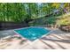 This backyard features an in-ground pool and lush green landscaping at 1583 Nantahalla Ne Ct, Atlanta, GA 30329