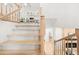View of the staircase with wooden railings and a glimpse of the living room and kitchen at 1583 Nantahalla Ne Ct, Atlanta, GA 30329