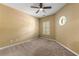 Bedroom with neutral walls, carpeted floors, plantation shutters, and a ceiling fan at 3219 Abbott Dr # 5, Powder Springs, GA 30127
