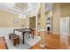 Inviting dining area featuring elegant lighting, wainscoting, and seamless flow to the living room at 3219 Abbott Dr # 5, Powder Springs, GA 30127