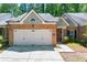 Charming brick front exterior featuring an attached two-car garage and manicured landscaping at 3219 Abbott Dr # 5, Powder Springs, GA 30127