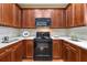 Well-equipped kitchen featuring classic wood cabinetry, modern appliances, and ample countertop space at 3219 Abbott Dr # 5, Powder Springs, GA 30127