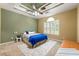 Comfortable main bedroom featuring a tray ceiling, ceiling fan, and large window at 3219 Abbott Dr # 5, Powder Springs, GA 30127