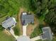 An aerial view displays the property's roof, driveway, and landscaping within a wooded, suburban cul-de-sac at 4219 David Austin Ct, Snellville, GA 30039