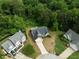 Aerial view of the home with surrounding mature trees and well-manicured lawn at 4219 David Austin Ct, Snellville, GA 30039