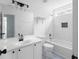 This bathroom features a white vanity, a tub with tile surround, and modern fixtures at 4219 David Austin Ct, Snellville, GA 30039