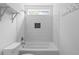 Fresh bathroom featuring tub with white subway tile, decorative shelves, and window at 4219 David Austin Ct, Snellville, GA 30039