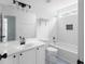 Well-lit bathroom featuring tub/shower combo and modern vanity with black hardware at 4219 David Austin Ct, Snellville, GA 30039