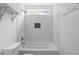 This bathroom features a shower-tub combo with white subway tile and tiled wall niche at 4219 David Austin Ct, Snellville, GA 30039