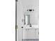 This bathroom features a white vanity with black hardware, a mirror, and decorative tile flooring at 4219 David Austin Ct, Snellville, GA 30039