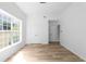 Bedroom with white paint, hardwood floors, closet, and a large window at 4219 David Austin Ct, Snellville, GA 30039