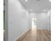 Clean bedroom space featuring light-colored wood flooring, white walls, and a glimpse of an outside view at 4219 David Austin Ct, Snellville, GA 30039