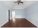 Open bedroom featuring a tray ceiling, fan, and new-looking hardwood floors at 4219 David Austin Ct, Snellville, GA 30039