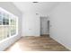 Bright bedroom with light wood flooring, a large window and a double door closet for ample storage at 4219 David Austin Ct, Snellville, GA 30039
