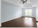Large bedroom with tray ceiling, ceiling fan, and hardwood-style flooring at 4219 David Austin Ct, Snellville, GA 30039