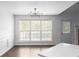 Dining area with large windows bringing in natural light, adjacent to the living room fireplace at 4219 David Austin Ct, Snellville, GA 30039