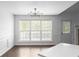 Dining area with large windows, neutral walls, and an adjacent doorway to the living area at 4219 David Austin Ct, Snellville, GA 30039
