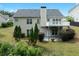 Back exterior view of a two-story home with a deck, patio, and well-maintained landscaping at 4219 David Austin Ct, Snellville, GA 30039
